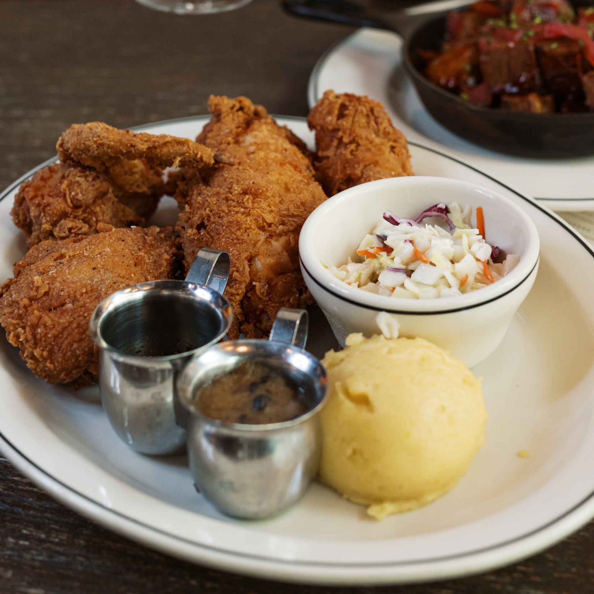 a plate of fried chicken and side dishes