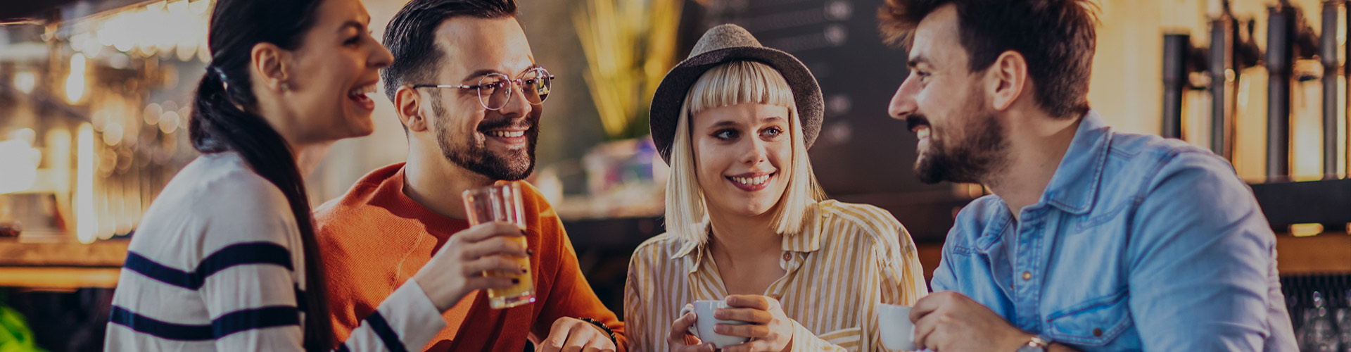 a group of people having a conversation over drinks