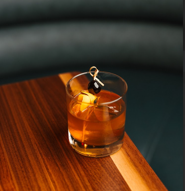 a glass with a drink and a rope on top