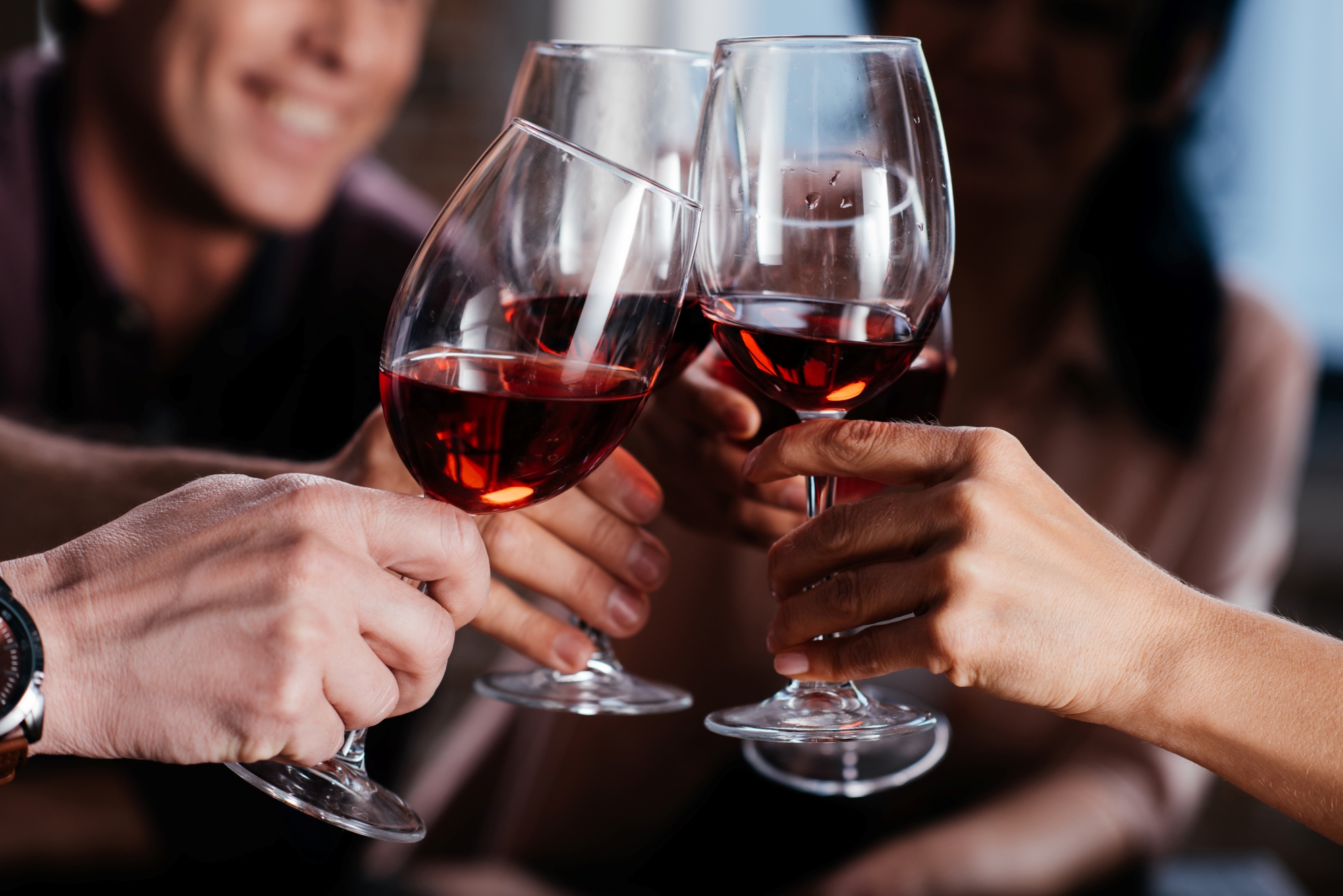 a group of people clinking wine glasses