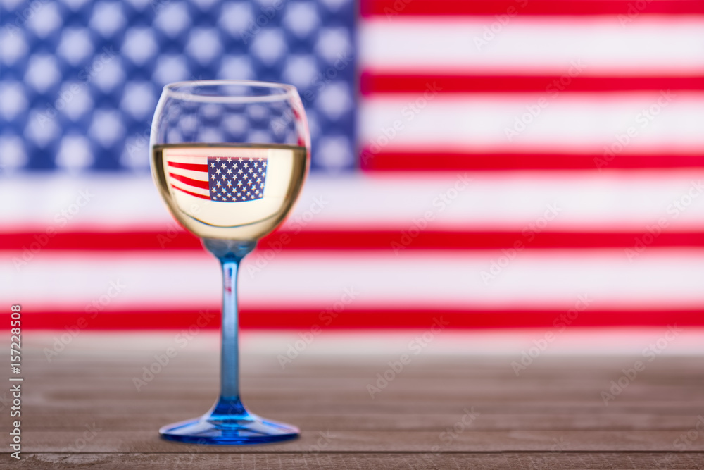 a glass of wine with a flag in the background