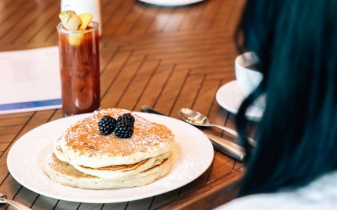 a plate of pancakes with berries on it