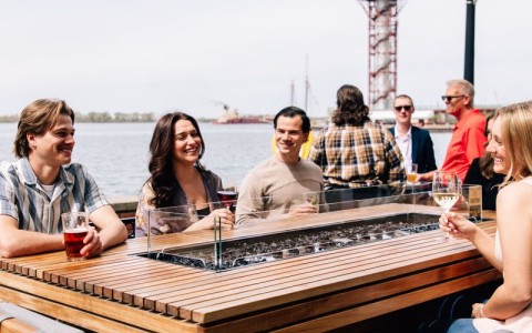 a group of people sitting at a table with drinks main