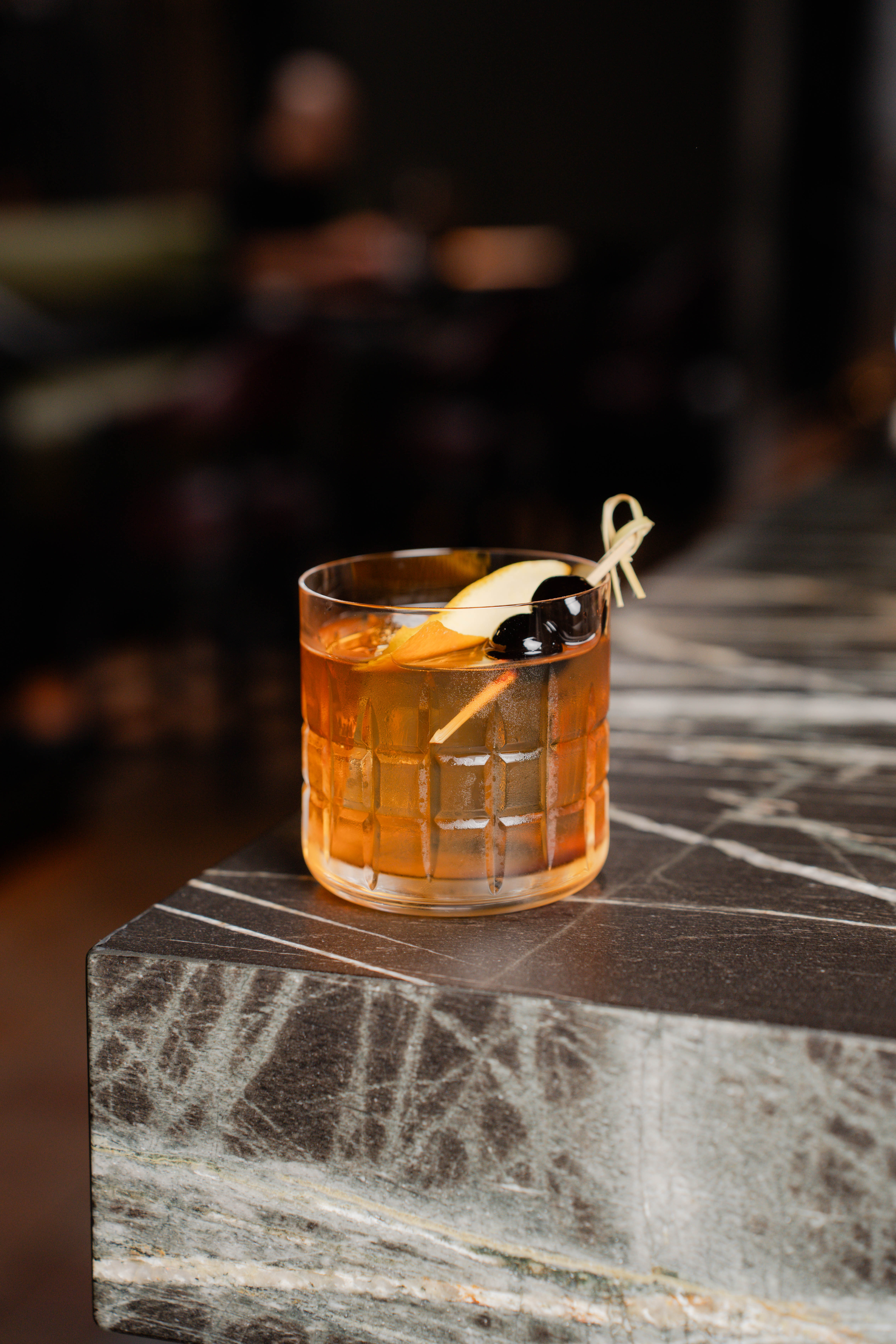 a glass of drink on a counter