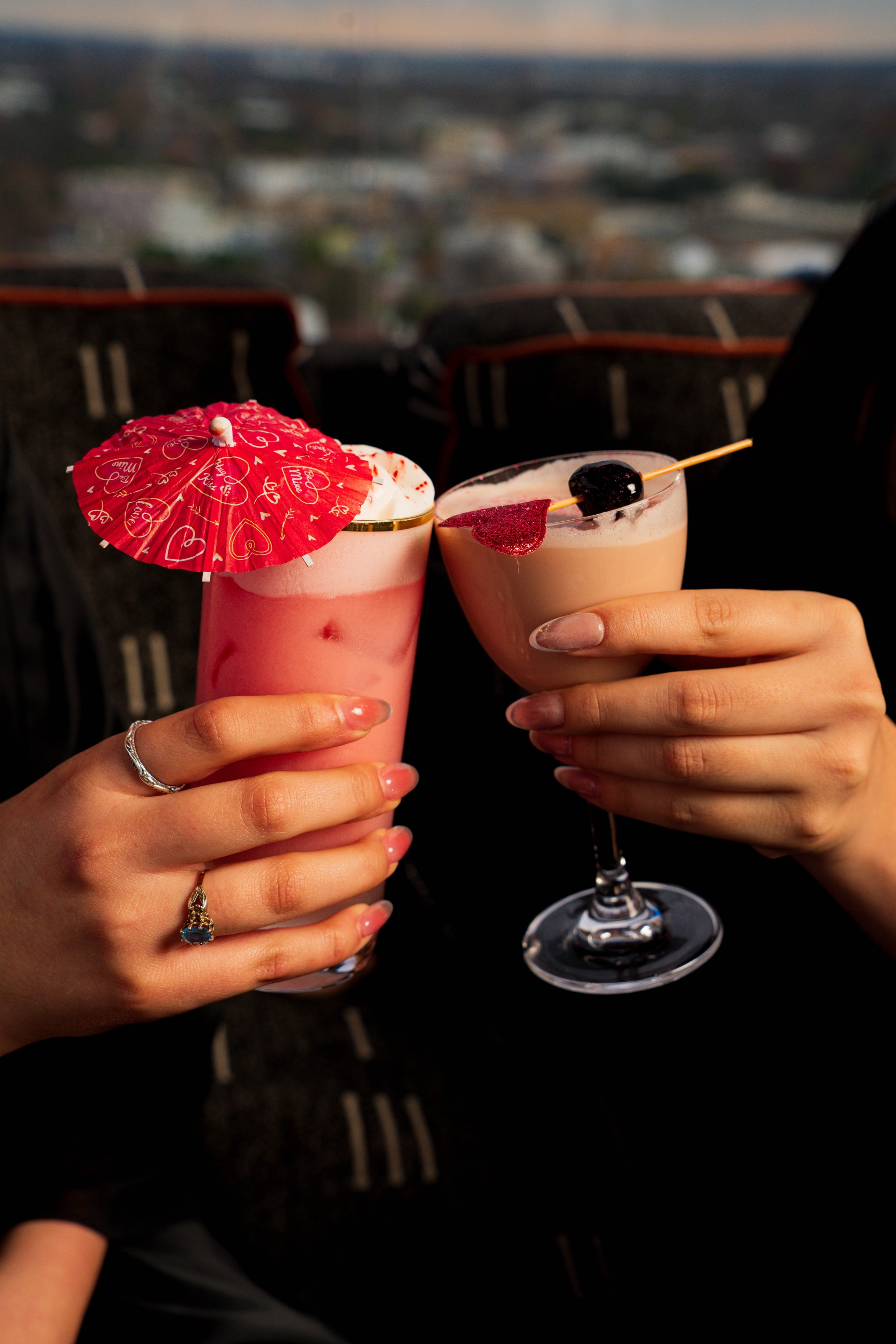 a pair of hands holding drinks