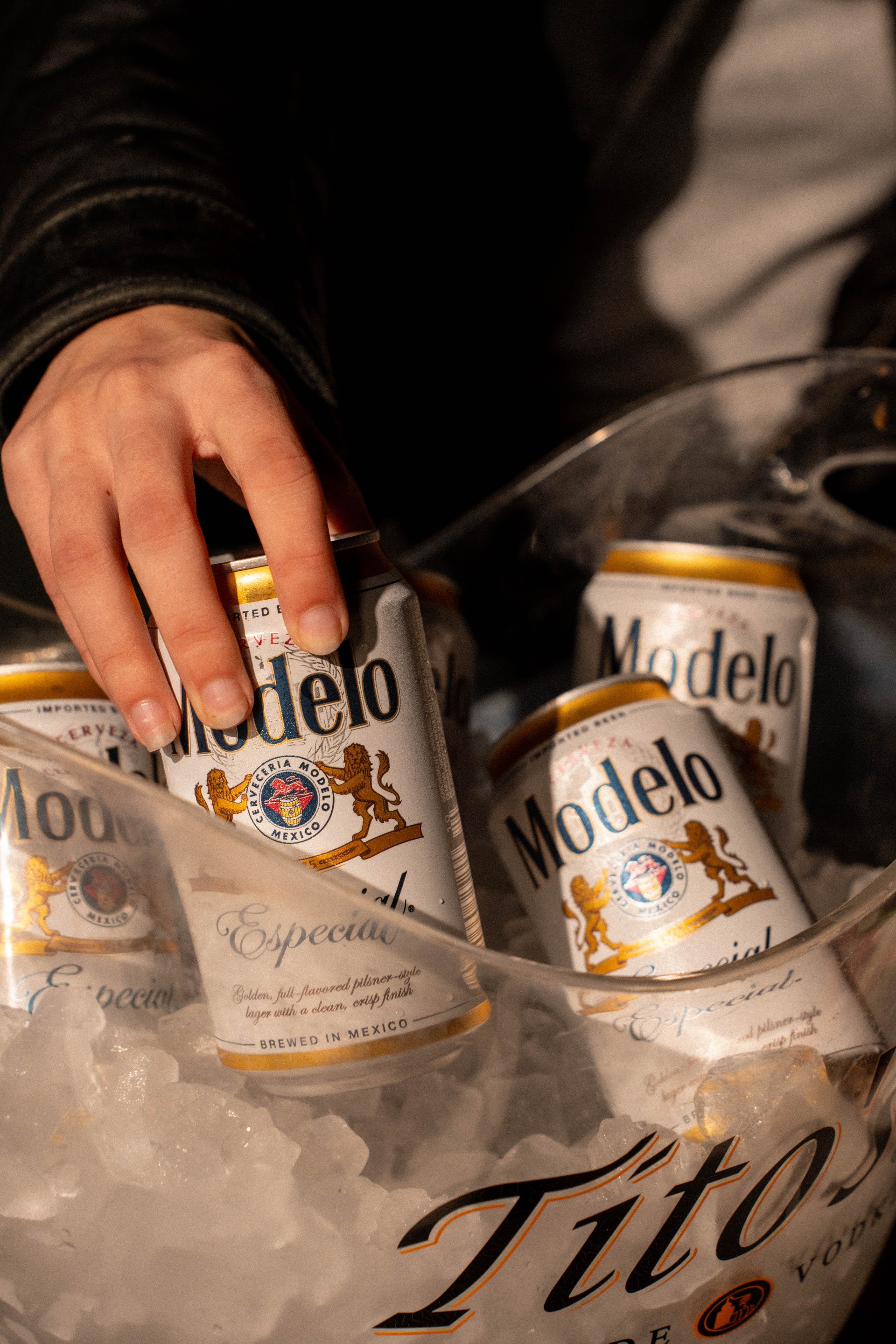 a hand holding a can of beer