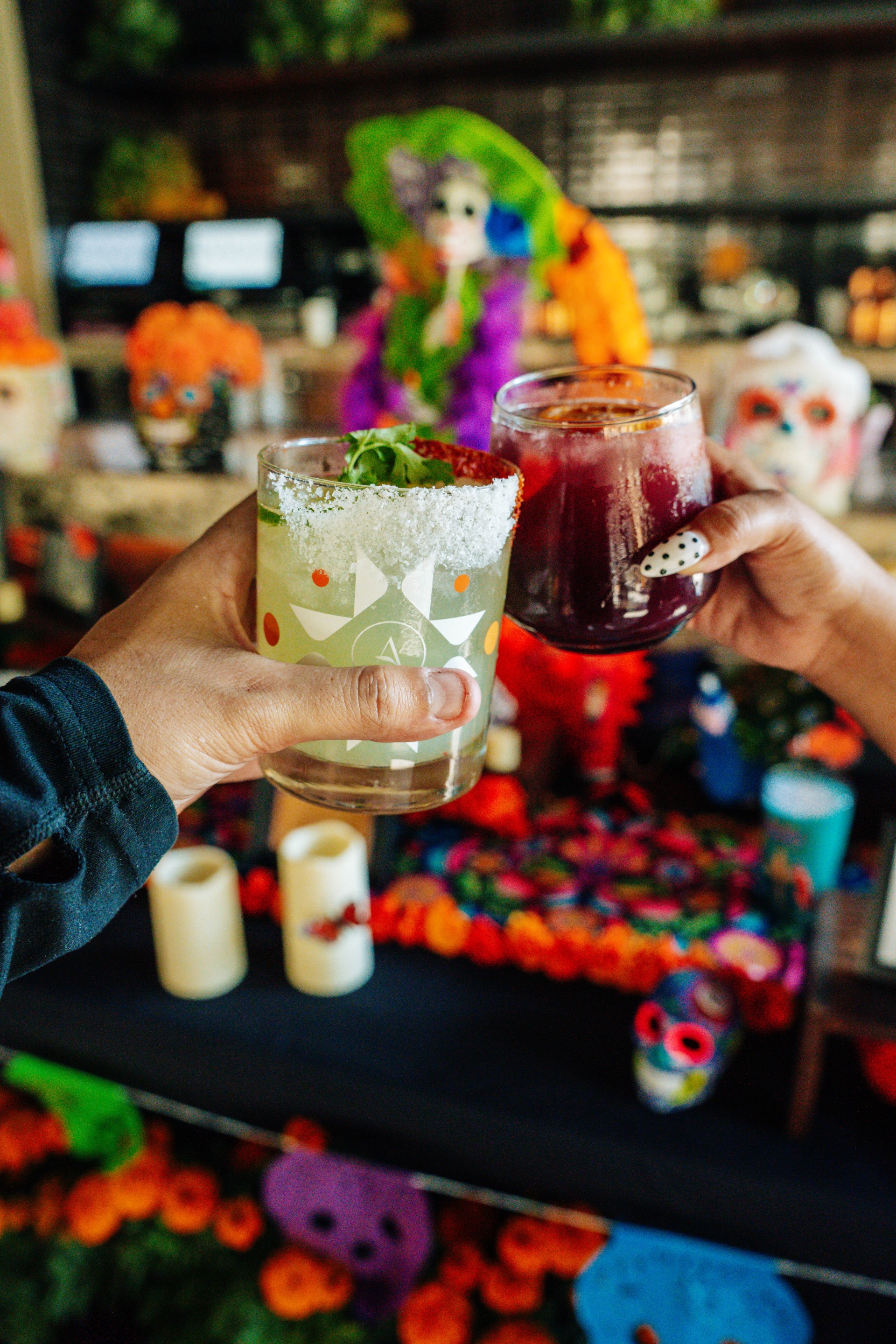 a pair of hands holding drinks