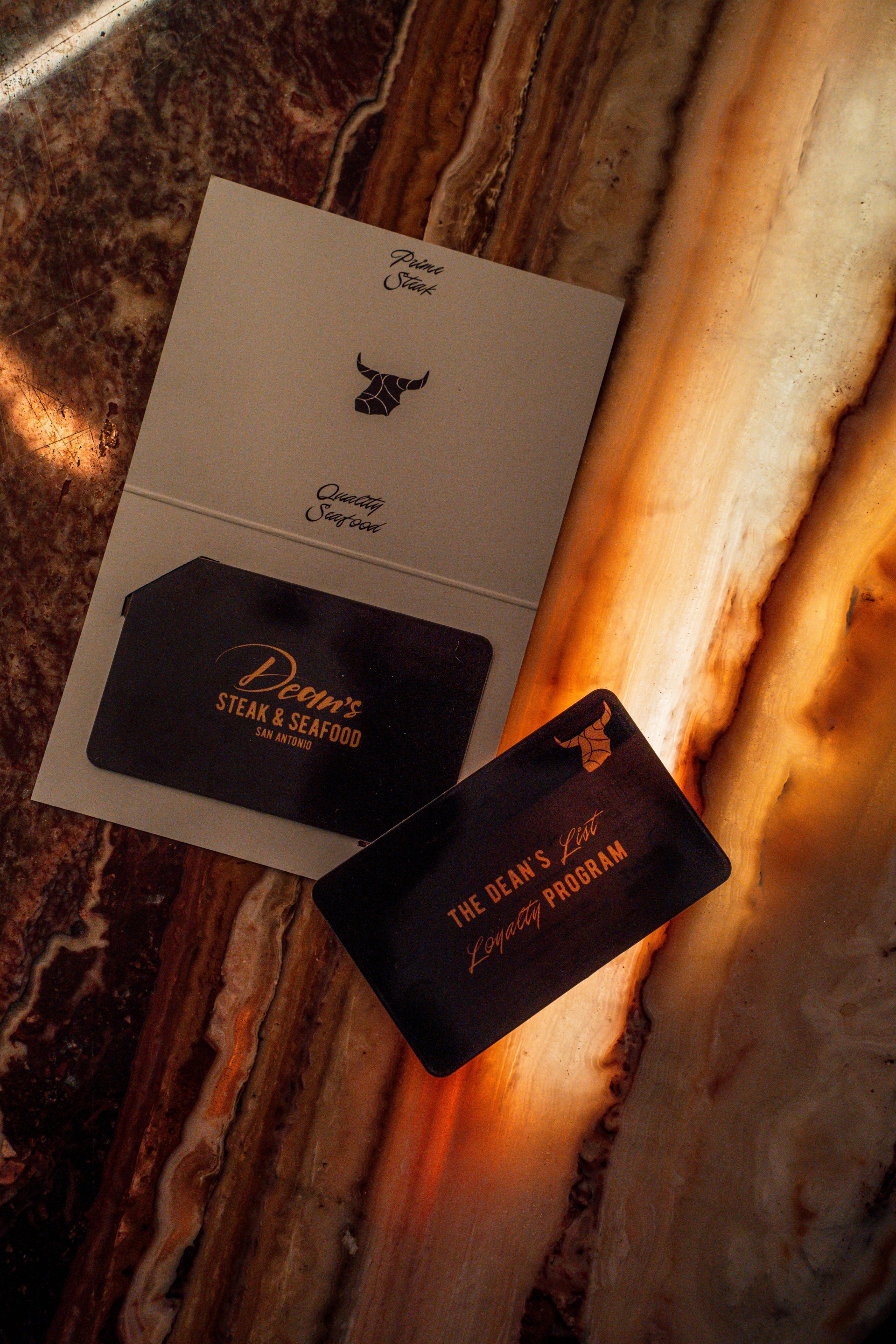 a black and gold business cards on a marble surface