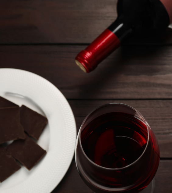 a glass of wine and a plate of chocolate