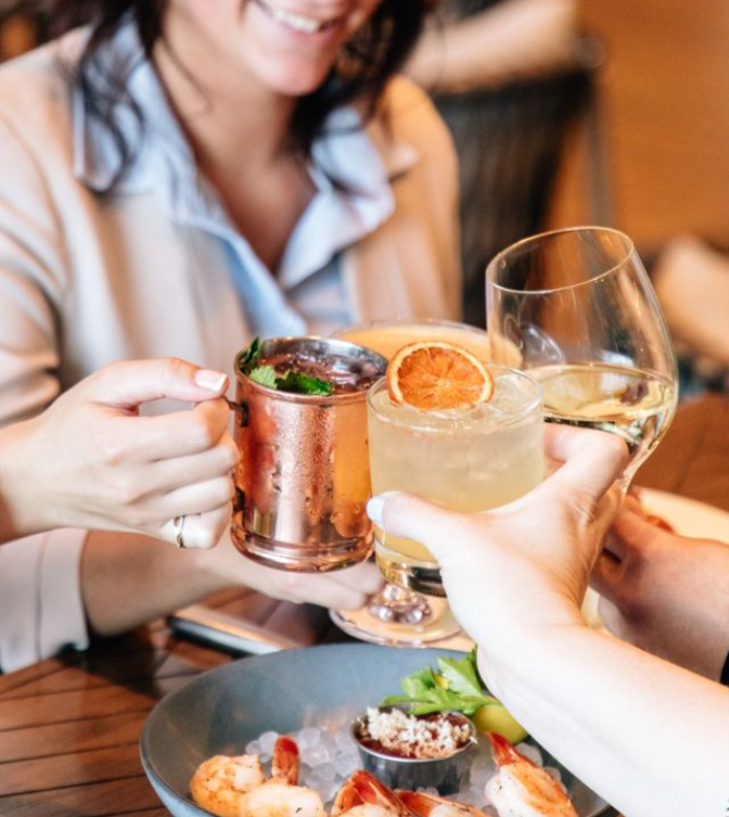 a group of people holding drinks