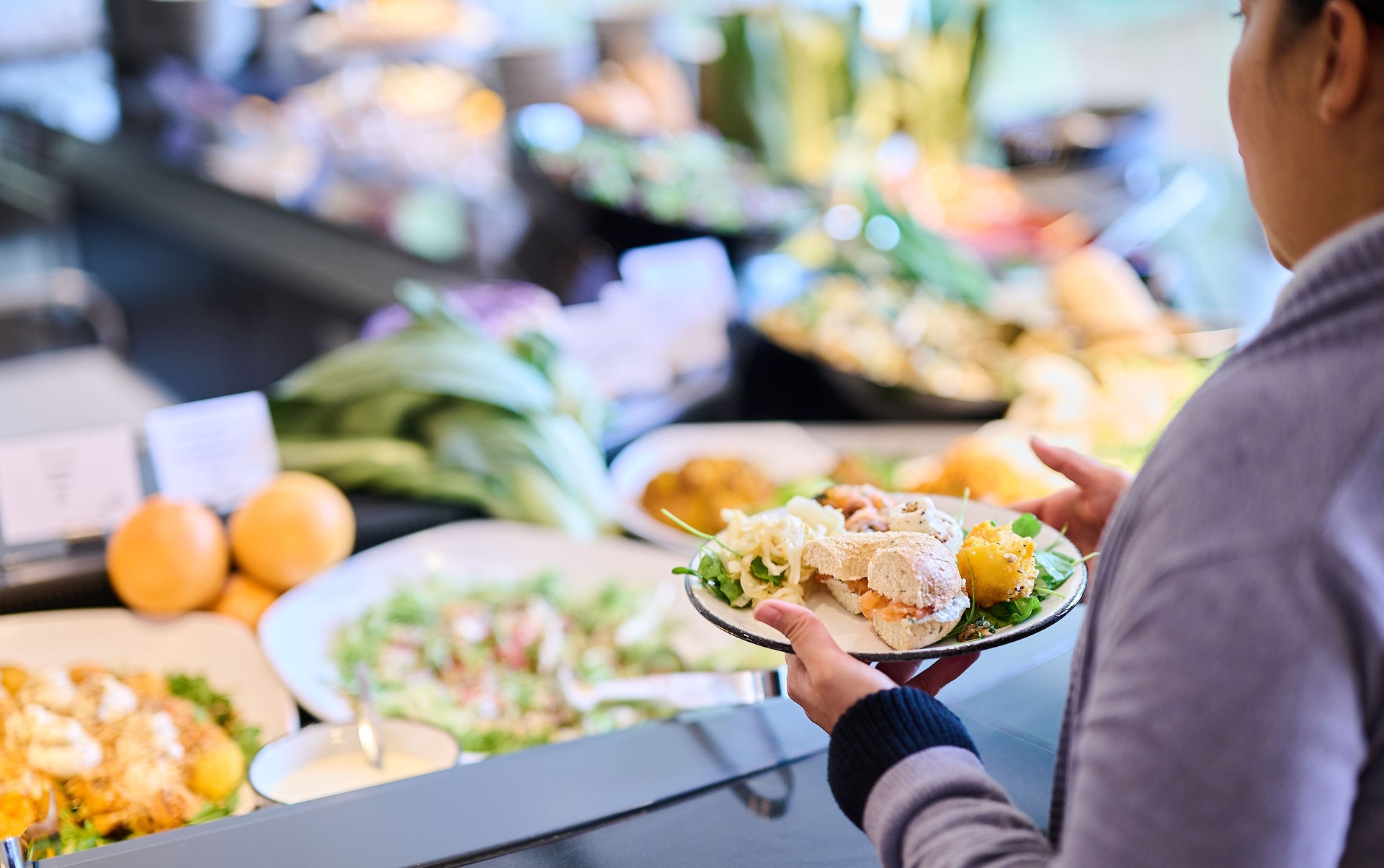 a person holding a plate of food