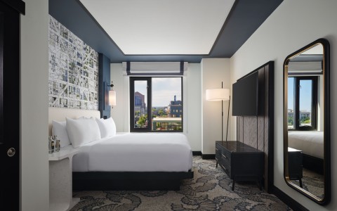 a room with a bed and a television