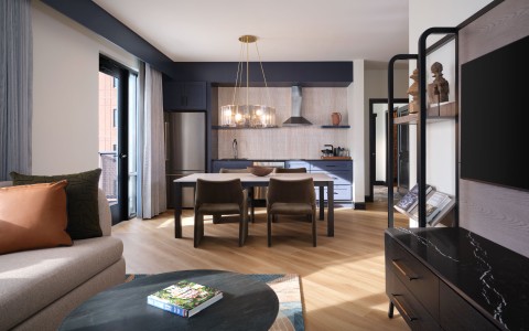 a living room with a table and chairs
