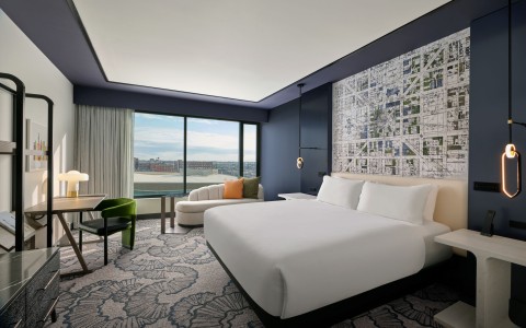 a room with a bed and a chair and a table