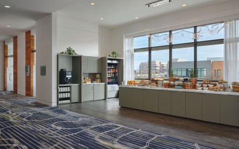 a room with a buffet and a large window