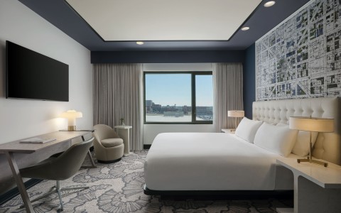 a room with a bed and a desk and chair