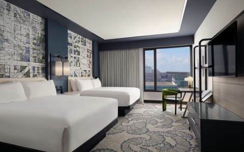 a room with two beds and a window