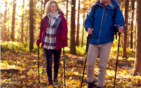 a man and woman hiking in the woods