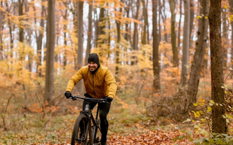a man riding a bike in the woods