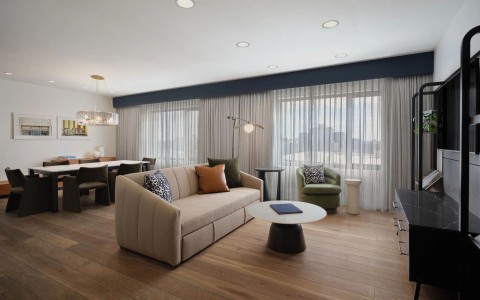 a room with a couch and chairs