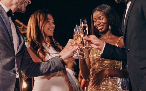 a group of people holding champagne glasses