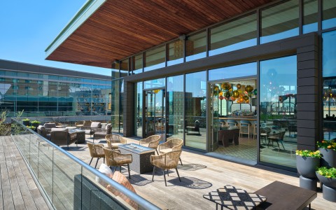 a patio with chairs and tables on a deck
