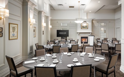 a room with a round table and chairs