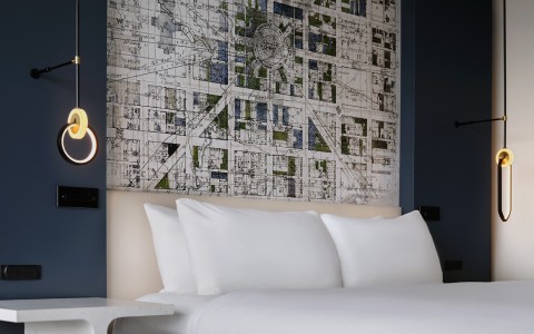 a bed with a map on the wall
