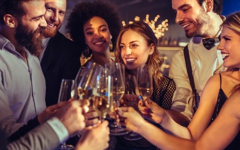 a group of people clinking glasses