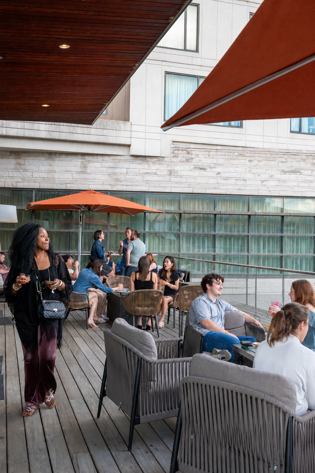 a group of people sitting at tables outside