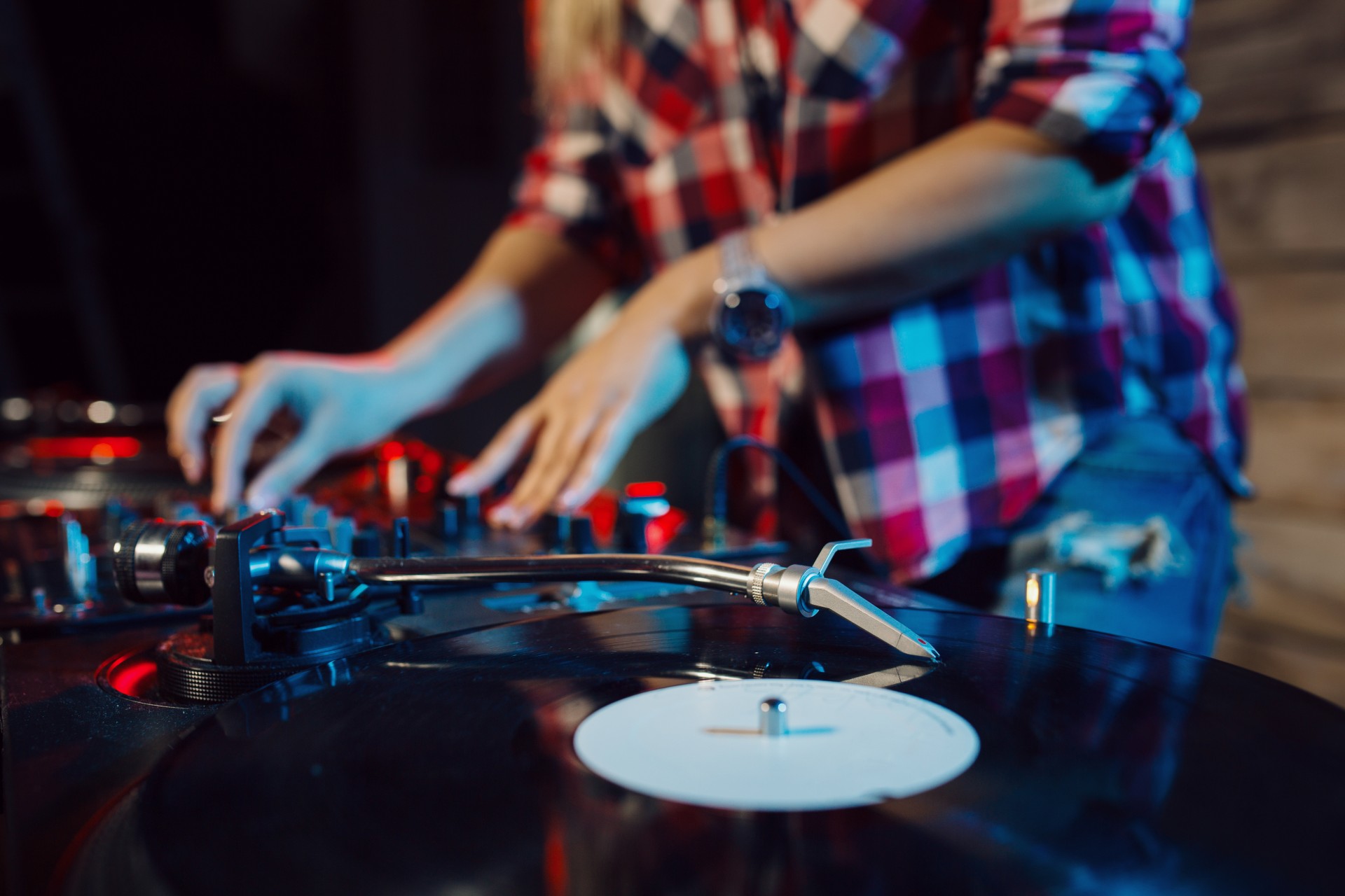 a person playing music on a record player