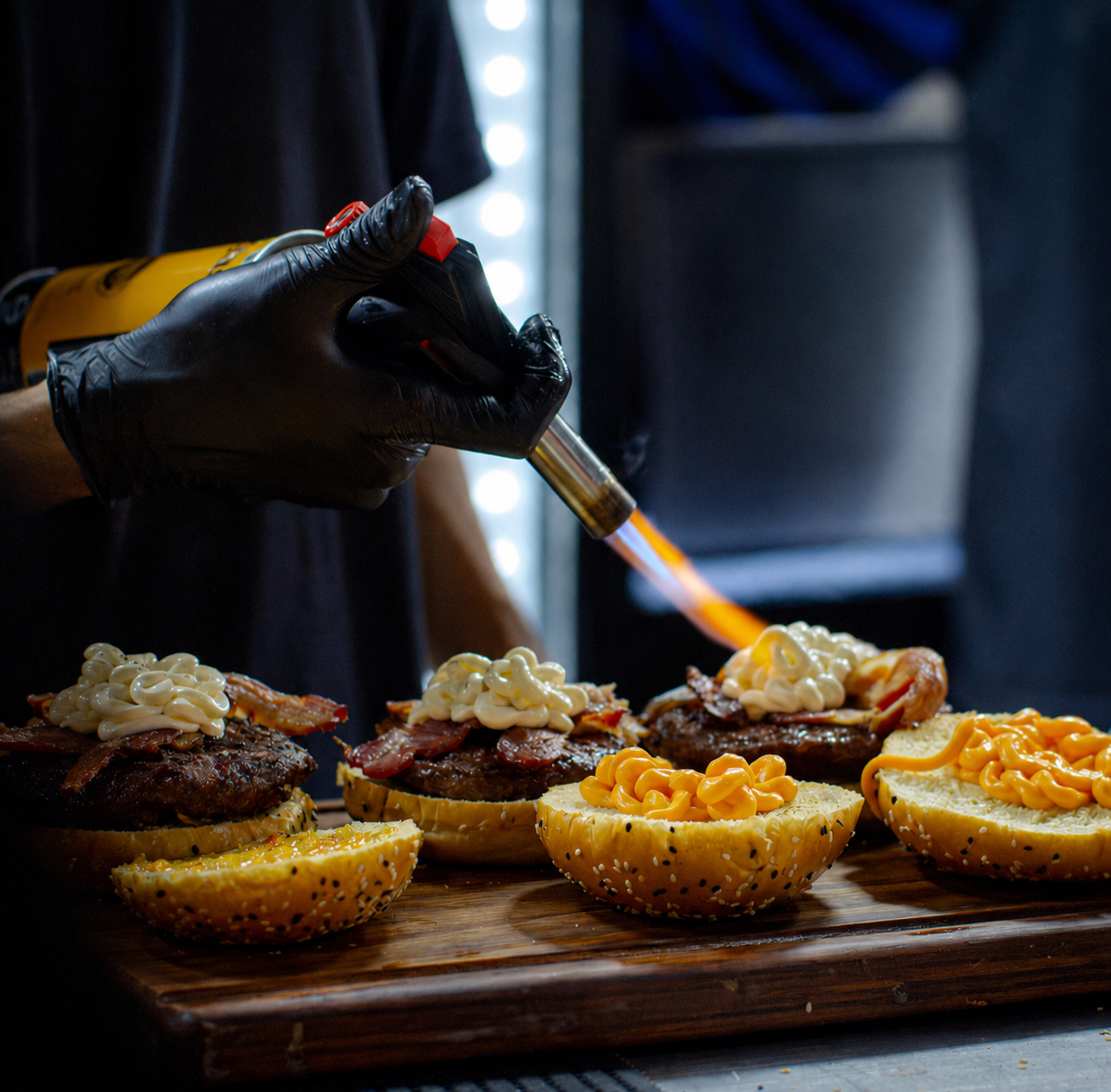 a person holding a torch over food