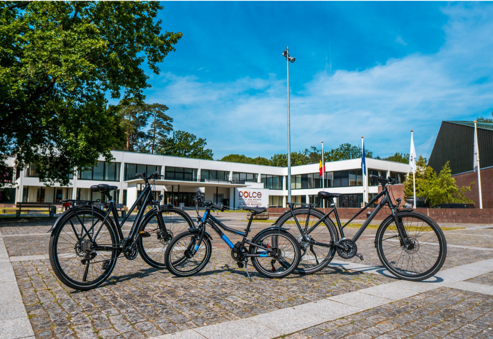 a group of bicycles parked on a brick road
