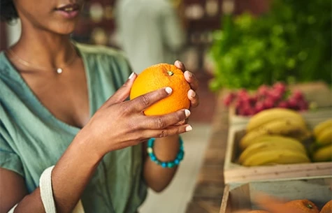 a woman holding an orange