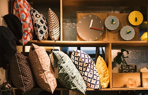 a shelf with various hats and shirts