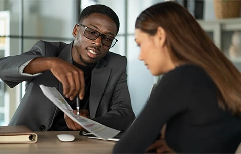 a man and a woman looking at a book