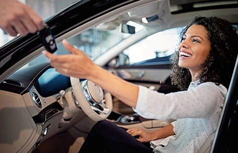 a woman holding a car key
