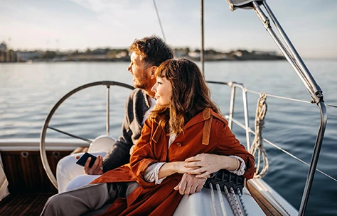 a man and woman sitting on a boat
