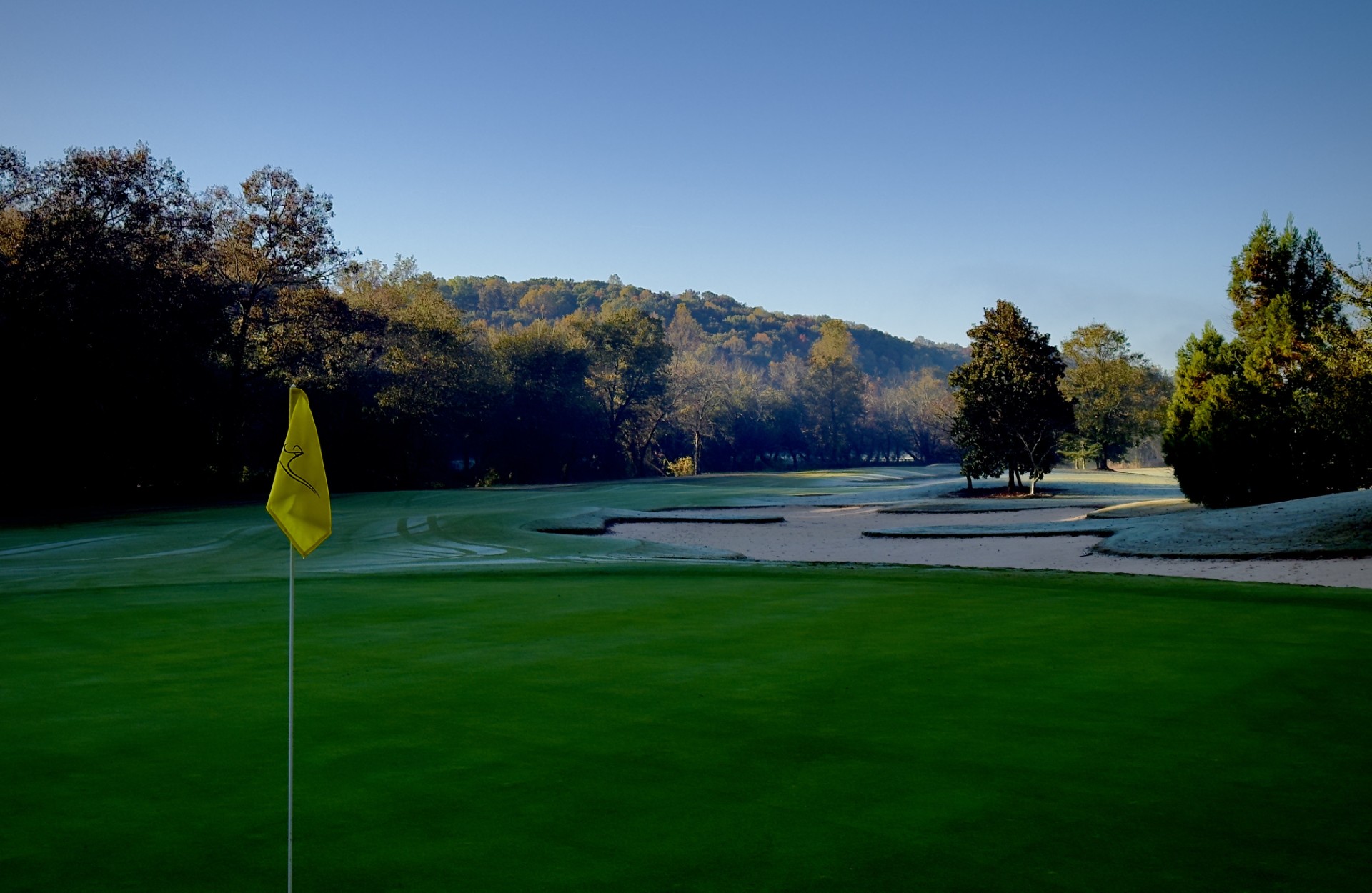 a golf course with a flag on the corner