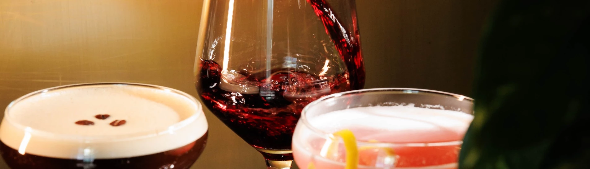 a glass of wine being poured into a glass