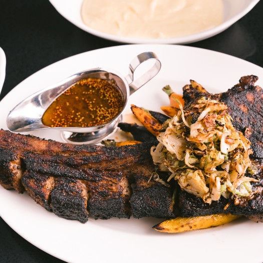 A well-done steak with gravy on the side