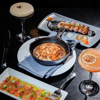 a table with plates of food and drinks