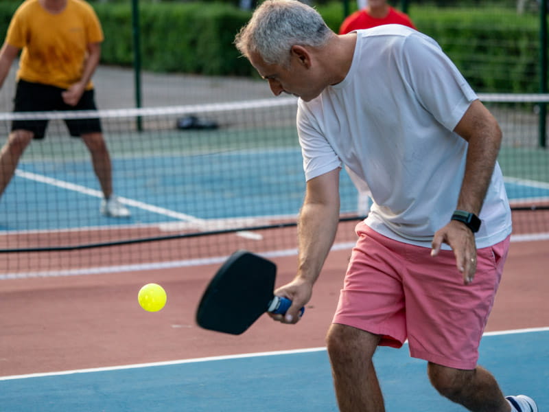 a man playing tennis on a court Next