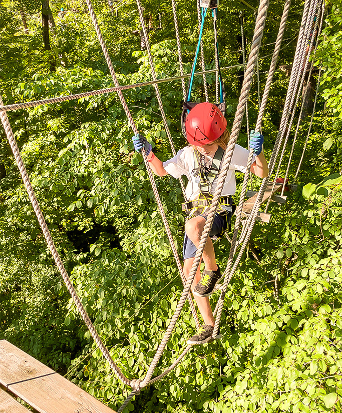 a person climbing a rope in the air