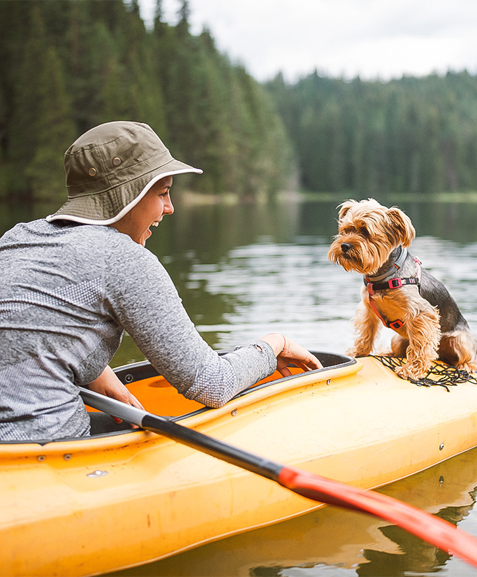 a man and a dog in a canoe