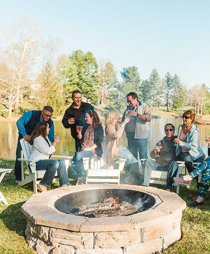 a group of people around a fire pit