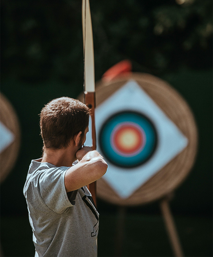 a man playing archery Next