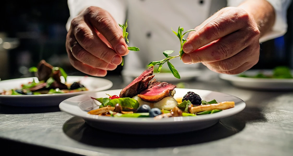 a person holding a plate of food