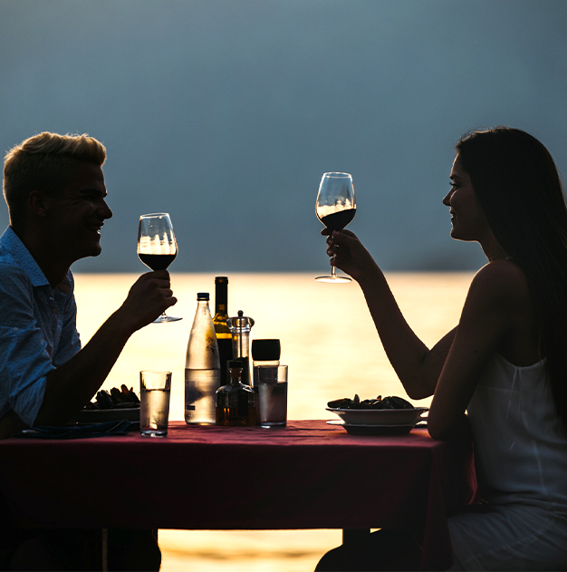 a man and woman drinking wine at a table