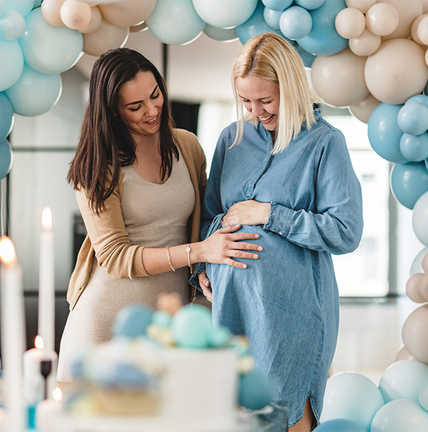 a woman touching a pregnant woman's belly